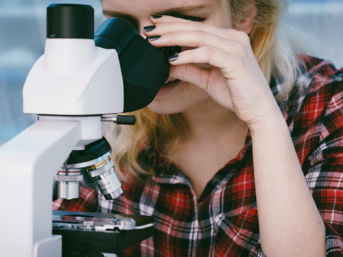 Image of a person using a microscope